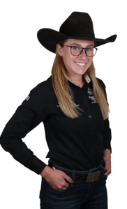 Stylish woman in western attire with cowboy hat and silver belt buckle.