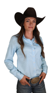 Woman in denim shirt and cowboy hat, exuding confident Western style.
