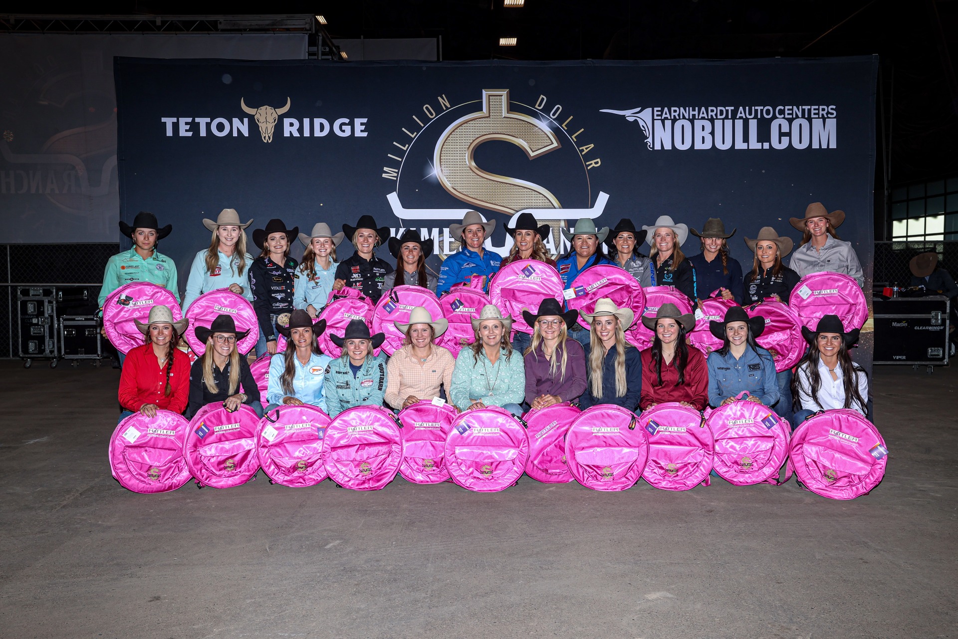 Group celebrating at Teton Ridge and NOBULL event with pink saddle pads and cowboy hats.